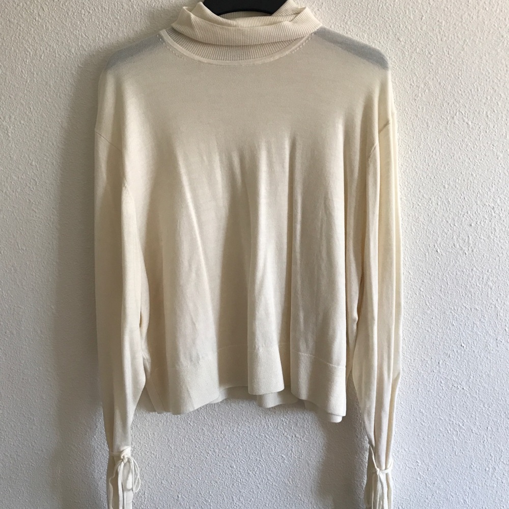 Tied arm turtle neck sweater